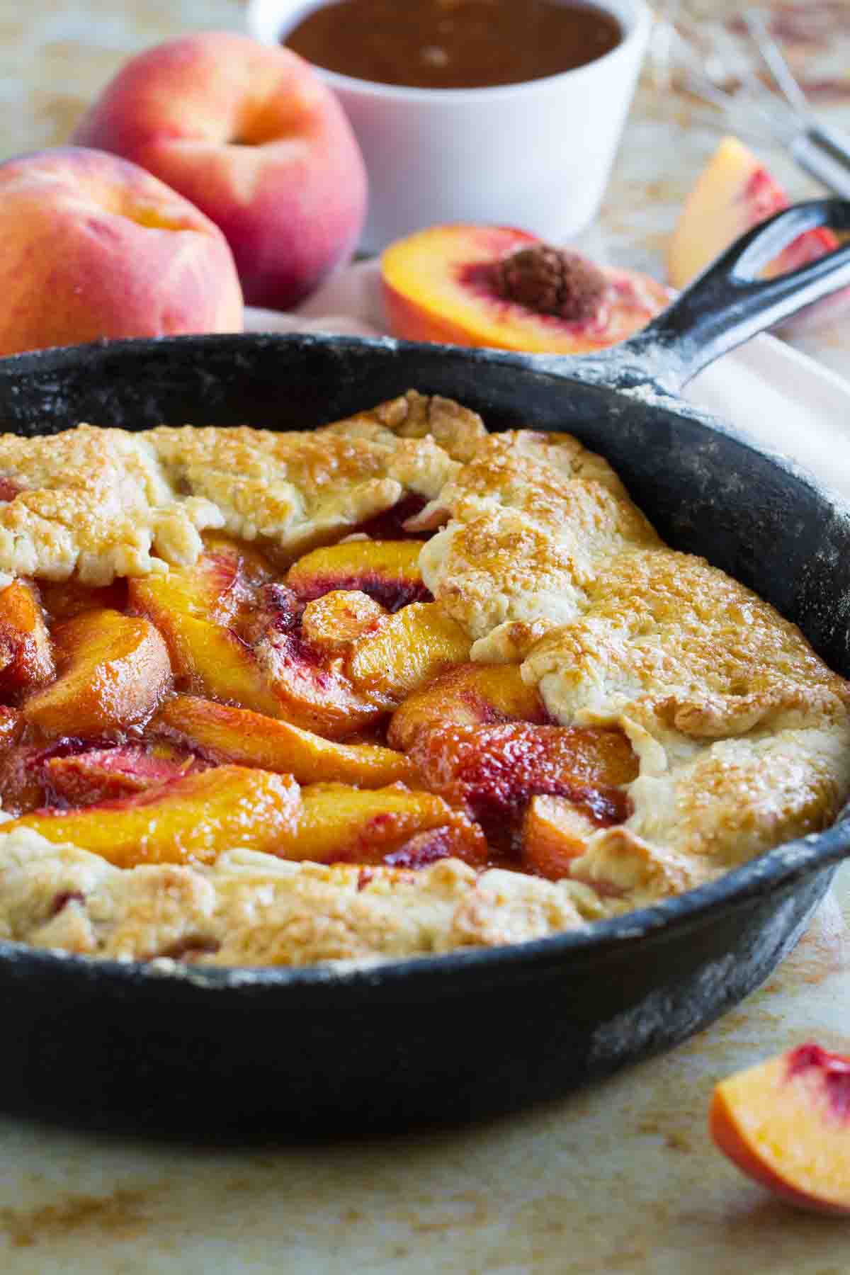 Sweet summer peaches fill this rustic pie baked in a cast iron skillet. This Cast Iron Peach Crostata Recipe will be on repeat during peach season! Cast Iron Peach Crostata with fresh peaches