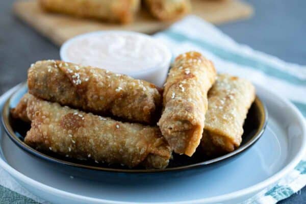 Cheeseburger Eggrolls on a plate with dipping sauce