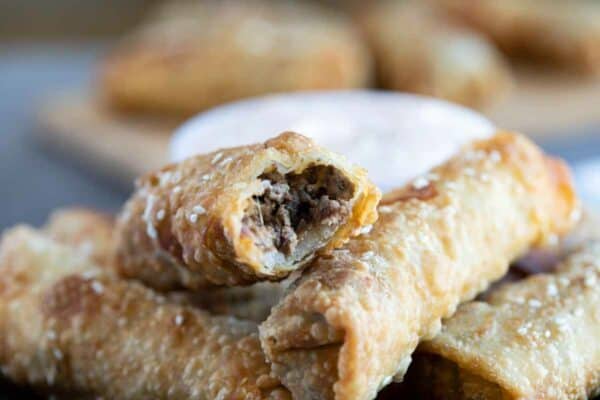 cheeseburger eggroll with a bite taken from it showing the filling