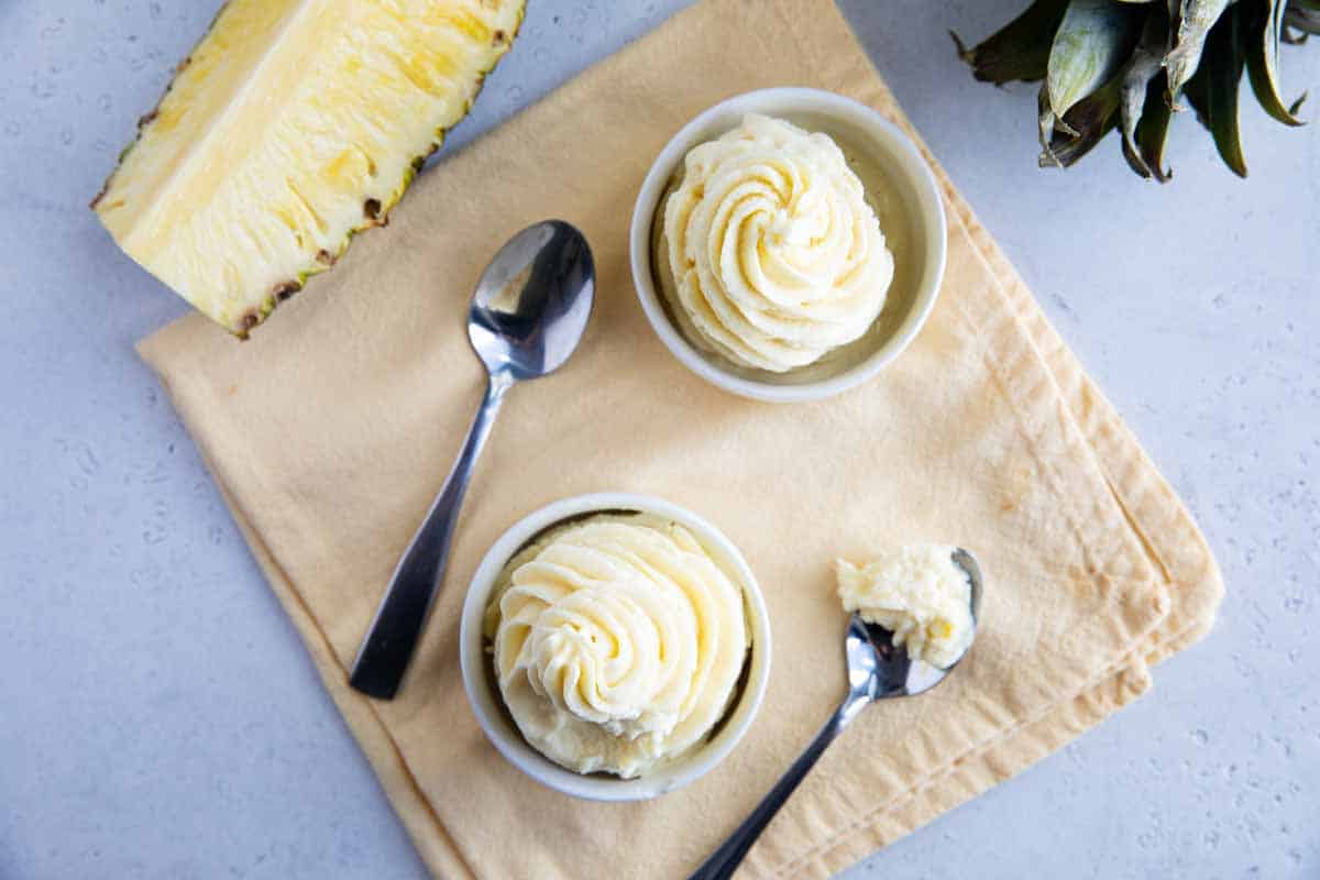 two bowls of dole whip with a bite taken from one