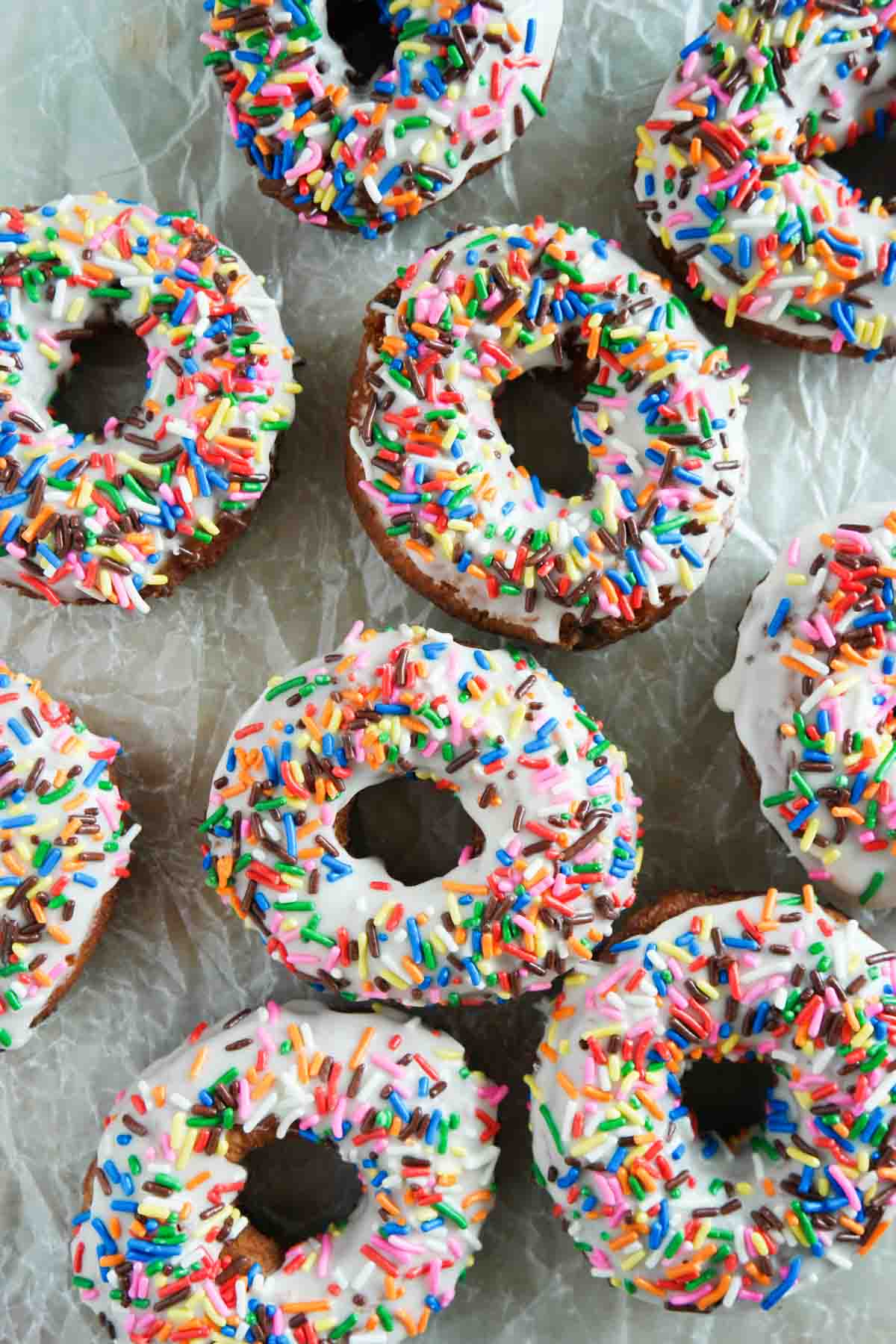 sprinkle donuts on parchment paper
