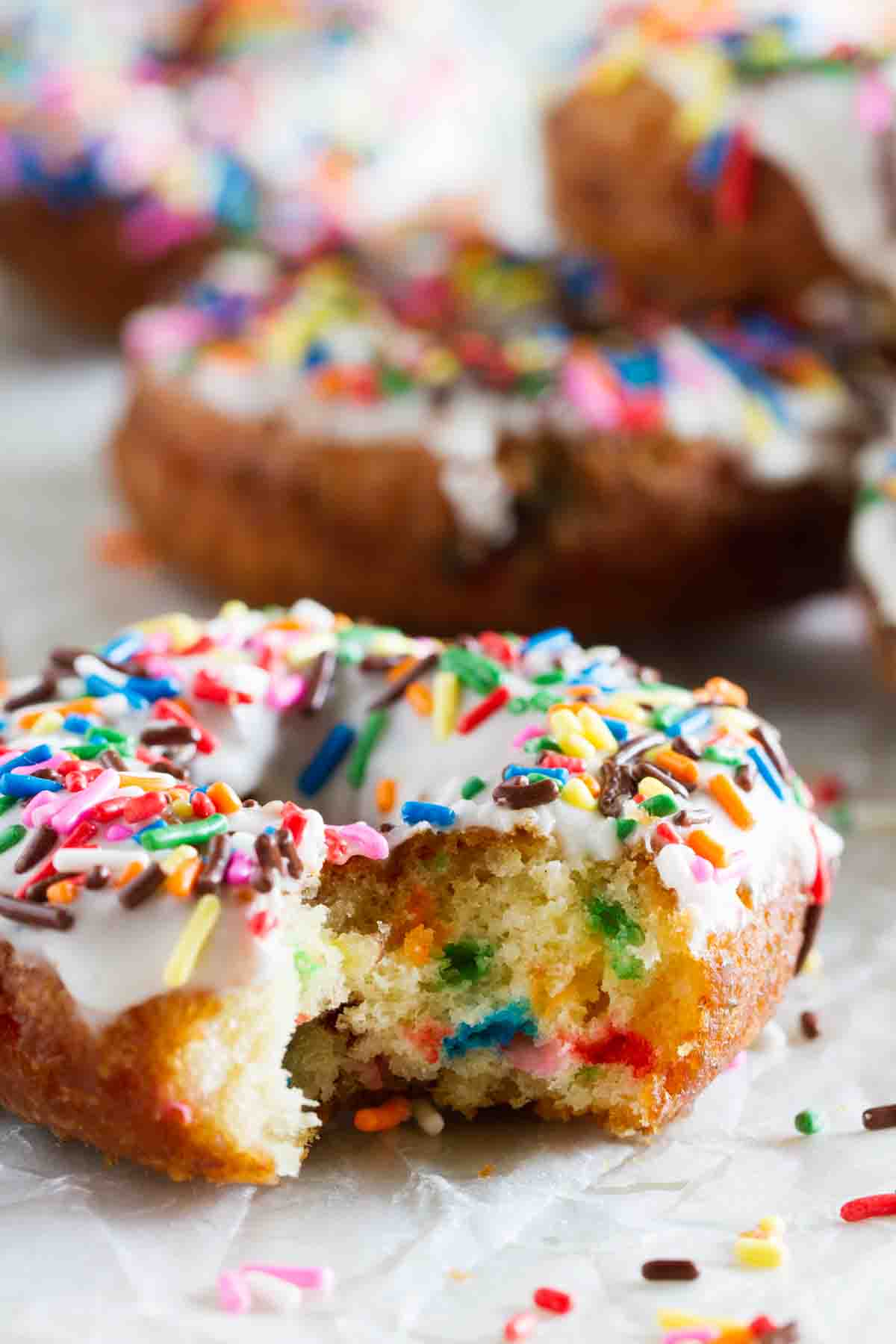 Funfetti donut with a bite taken from it