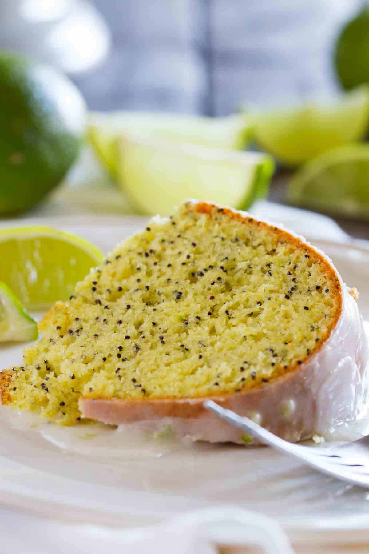 slice of Lime Poppy Seed Cake on a plate with a fork
