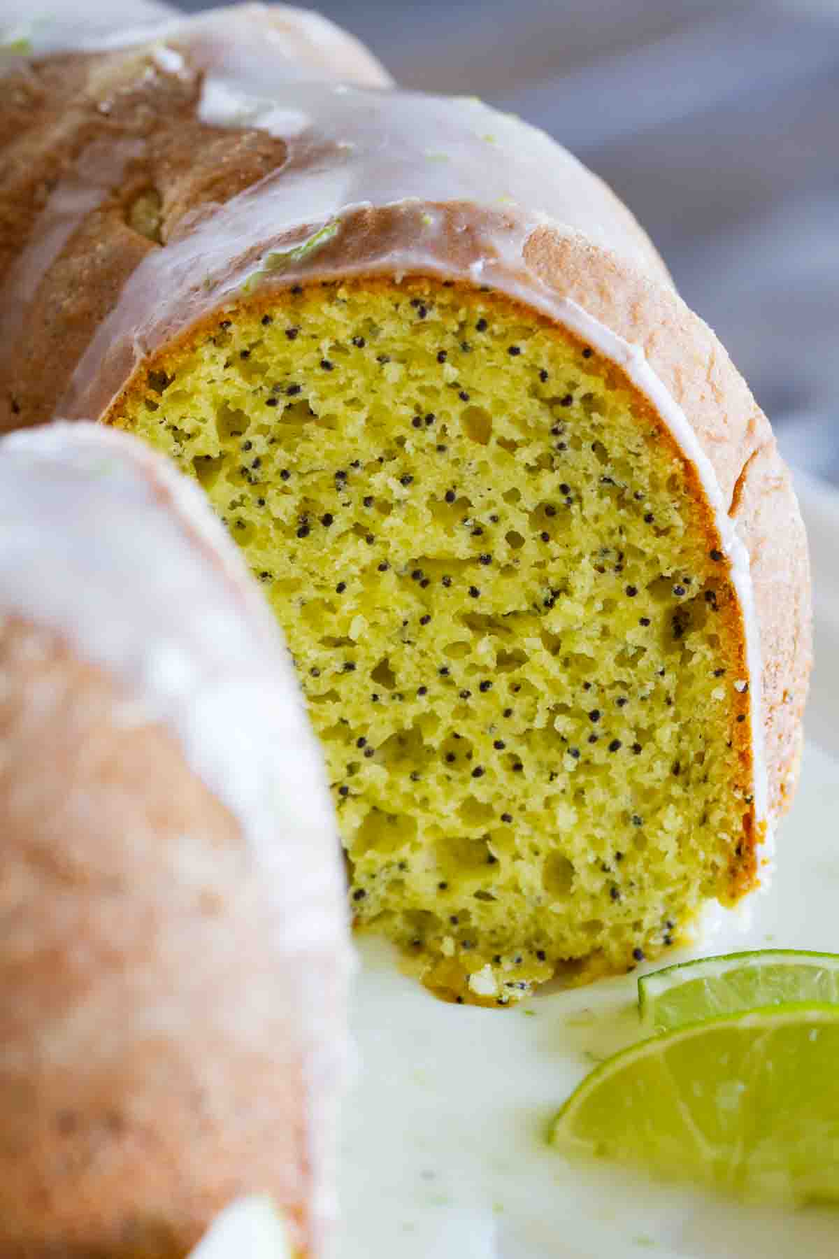 Lime Poppy Seed Cake with a slice taken to show inside of cake