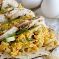 Migas tacos with avocado on flour tortillas