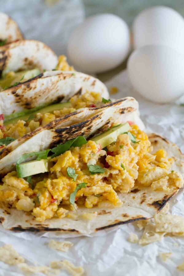 Migas tacos with avocado on flour tortillas