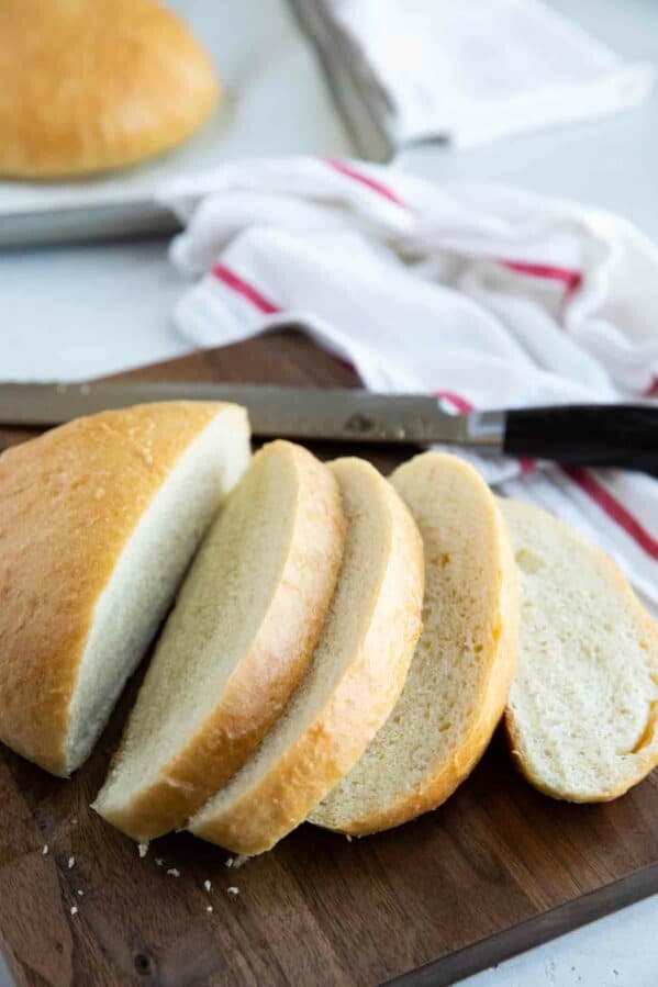 Round of sliced peasant bread on a cutting board