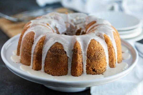 Sour Cream Coffee Cake with glaze on a cake platter