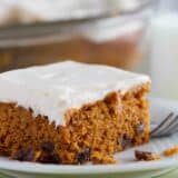 Slice of Tomato Soup Spice Cake topped with cream cheese frosting