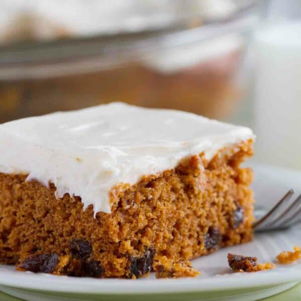 Slice of Tomato Soup Spice Cake topped with cream cheese frosting