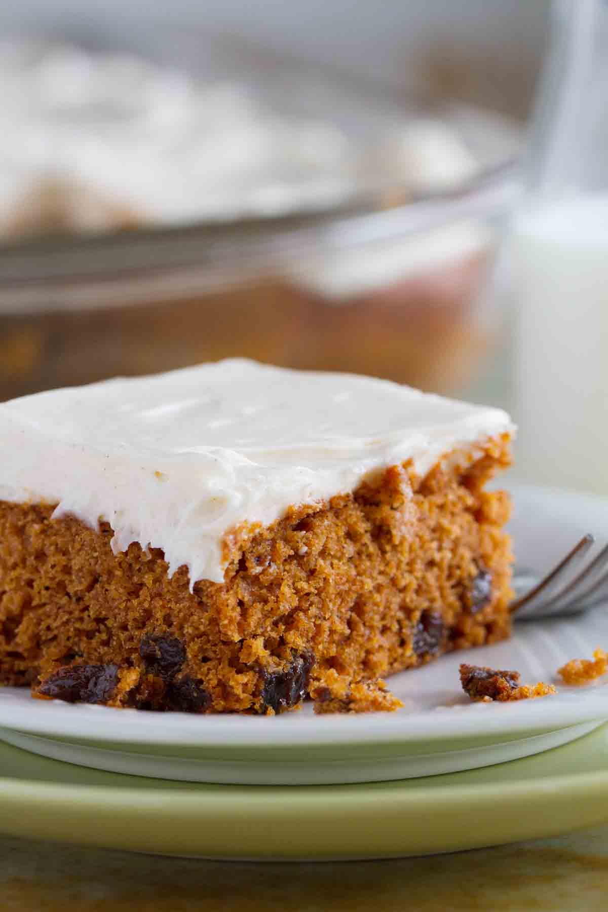 Slice of Tomato Soup Spice Cake topped with cream cheese frosting