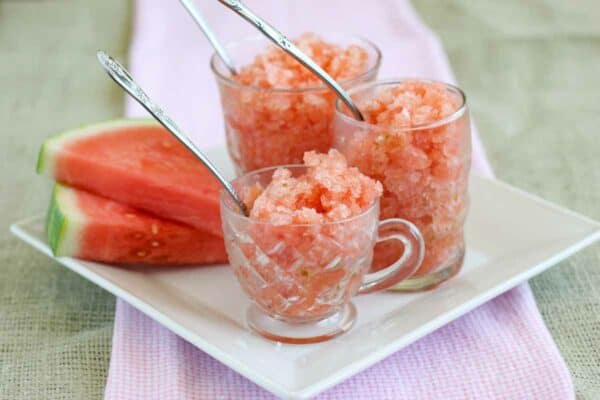 Three cups filled with watermelon granita with ginger and lime