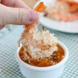 Dipping a baked coconut shrimp into basil peach sauce.