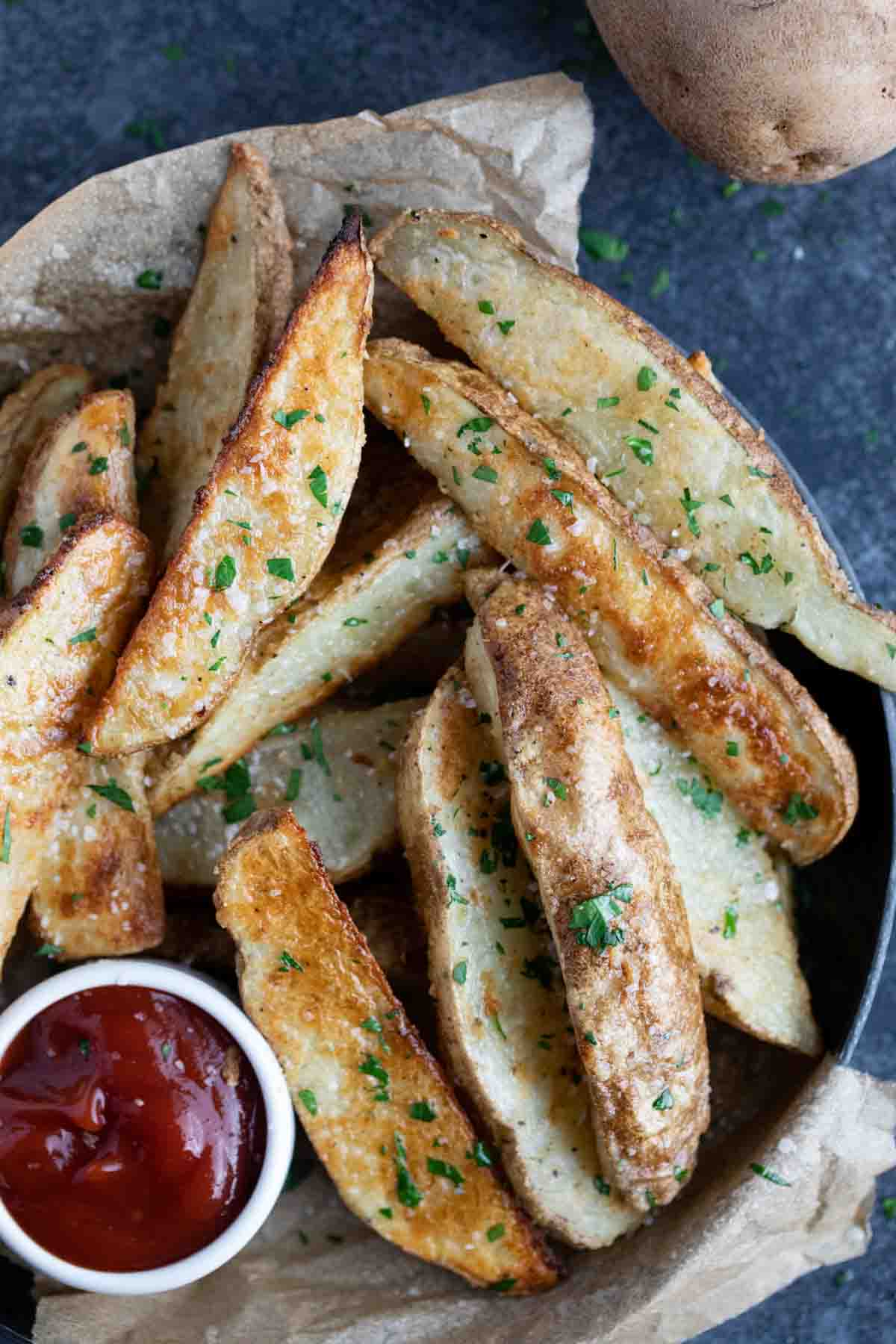 baked potato wedges sprinkled with salt and parsley.