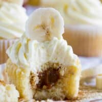 Bananas Foster Cupcake with a bite taken out showing caramel center.
