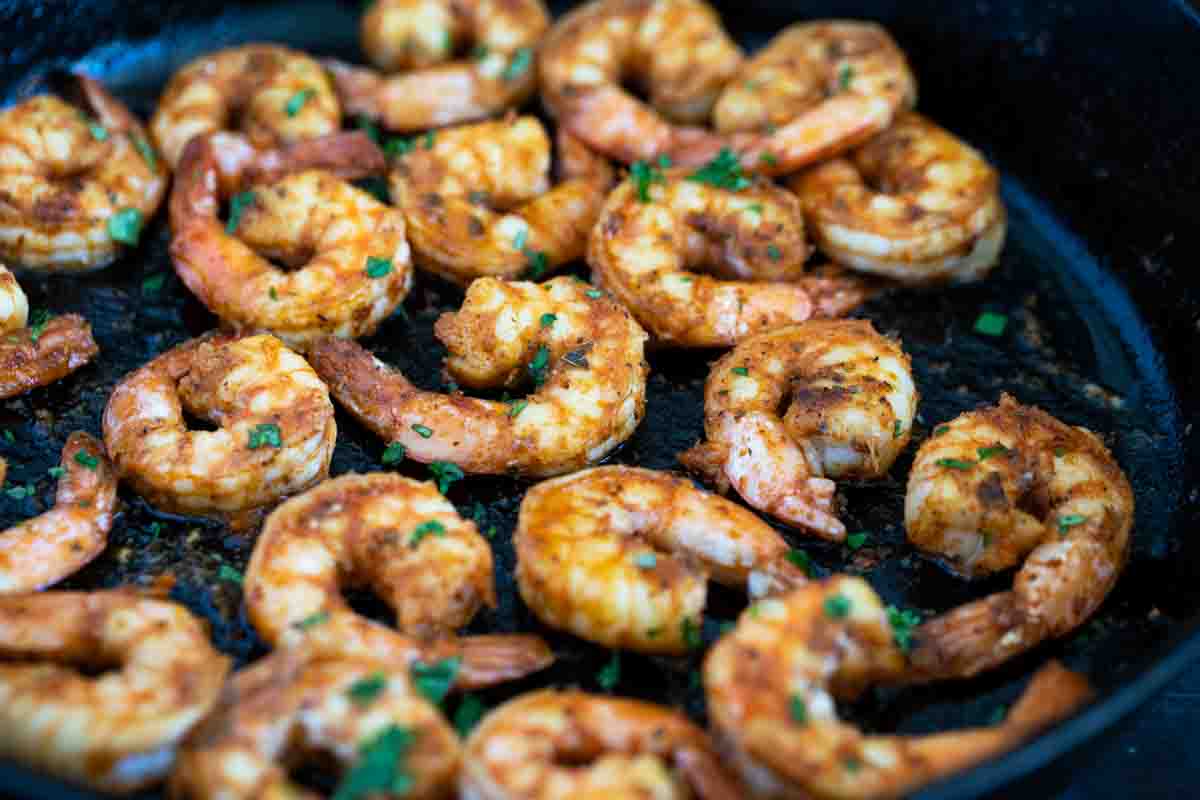 Shrimp with Cajun seasoning cooked in a cast iron skillet. This Cajun Shrimp just may be the easiest recipe ever! All it takes is about 5 minutes for this easy shrimp recipe. Serve the shrimp over grits, pasta, or by themselves for a spicy, flavorful dish.