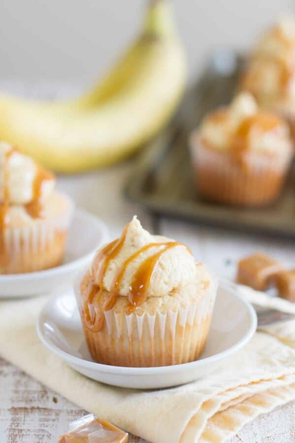 Caramel Banana Cupcakes drizzled with caramel on a plate