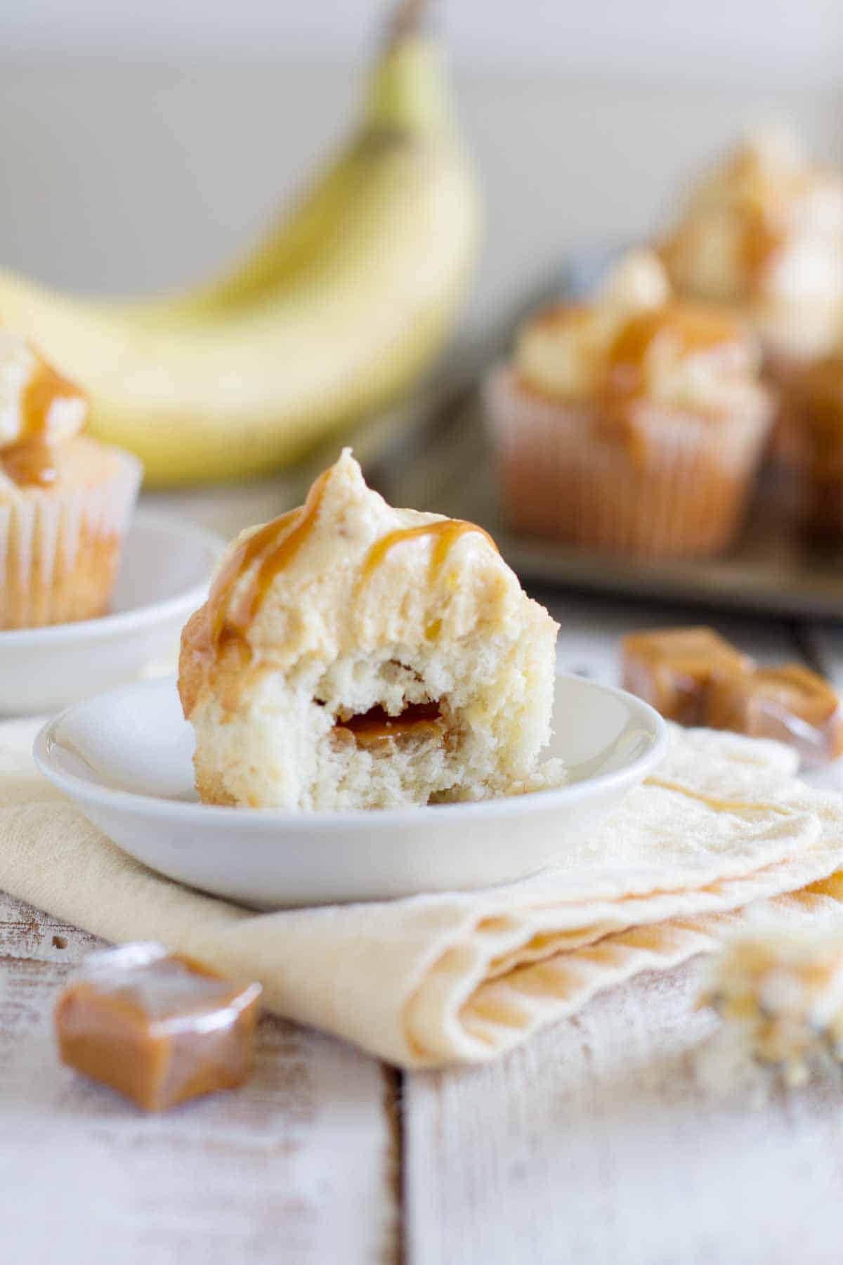 caramel banana cupcake with a bite taken from it