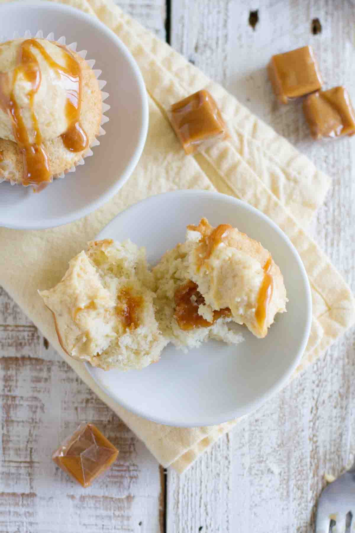 caramel banana cupcake torn in half showing the caramel center