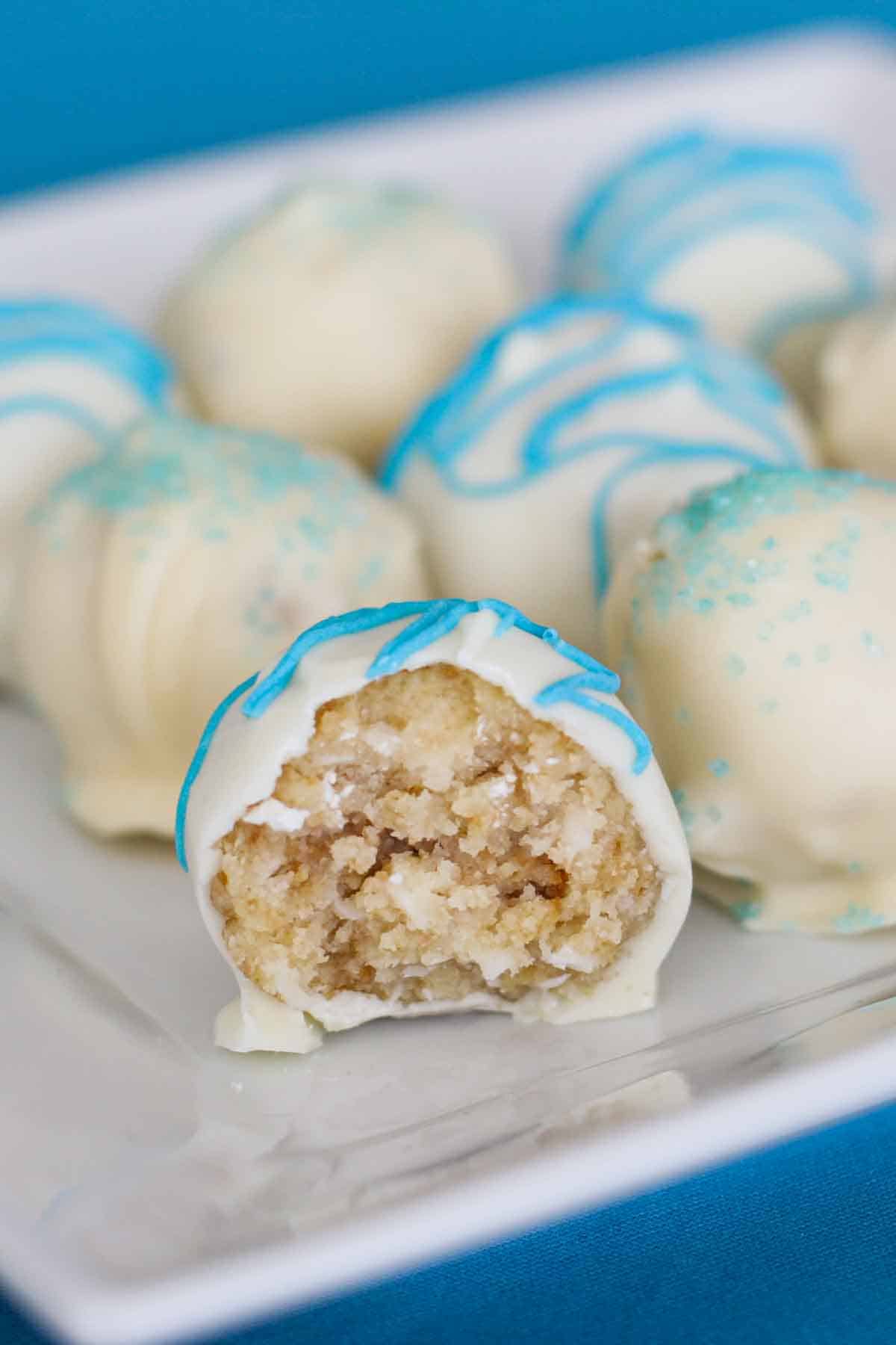 Coconut Cake Truffle with a bite taken from it.