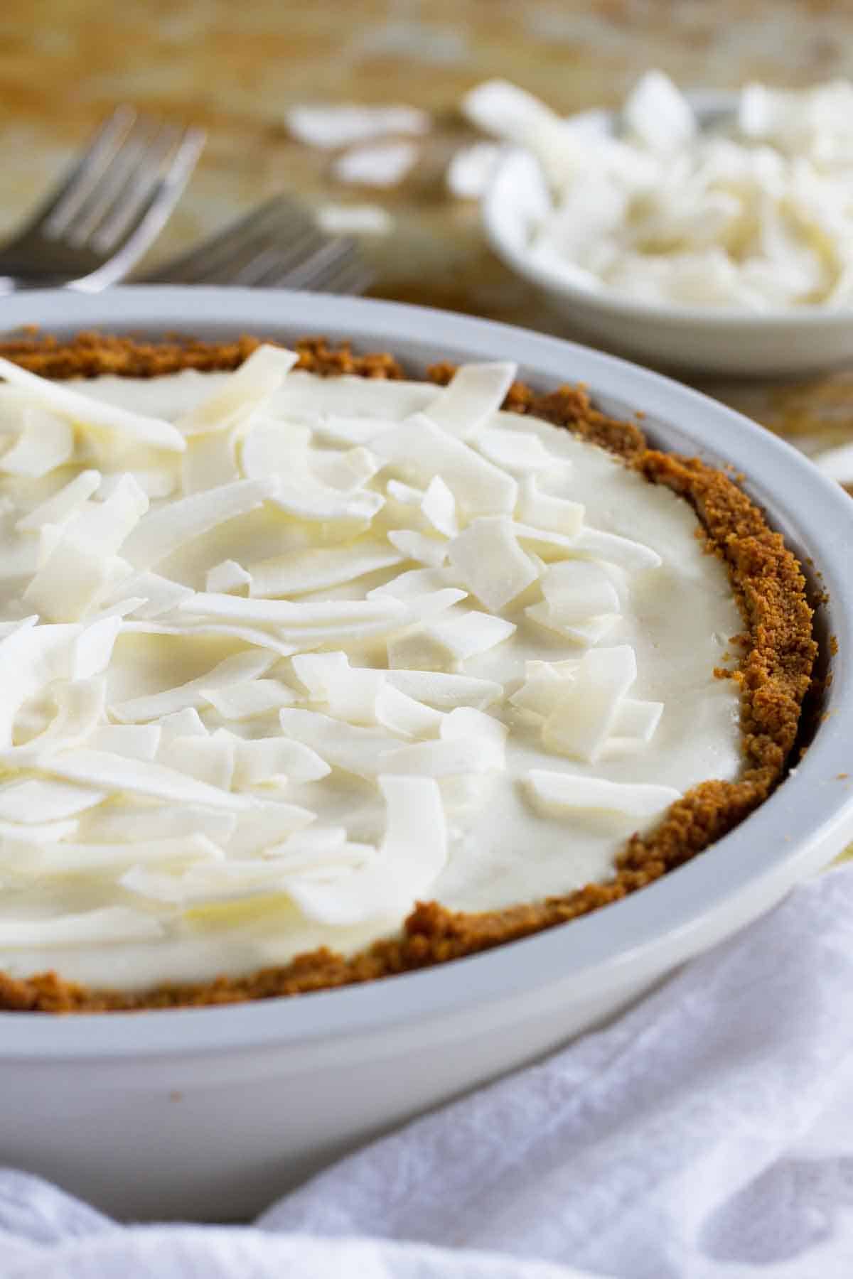 Coconut Cheesecake Pie topped with large pieces of shredded coconut.