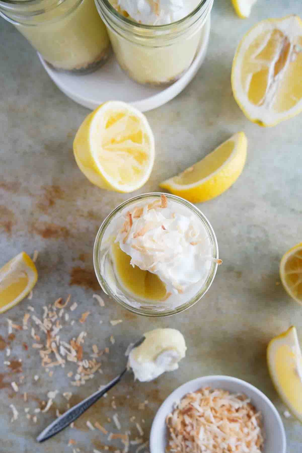 Coconut Lemon Pudding Parfait topped with whipped cream with a bite taken from it.