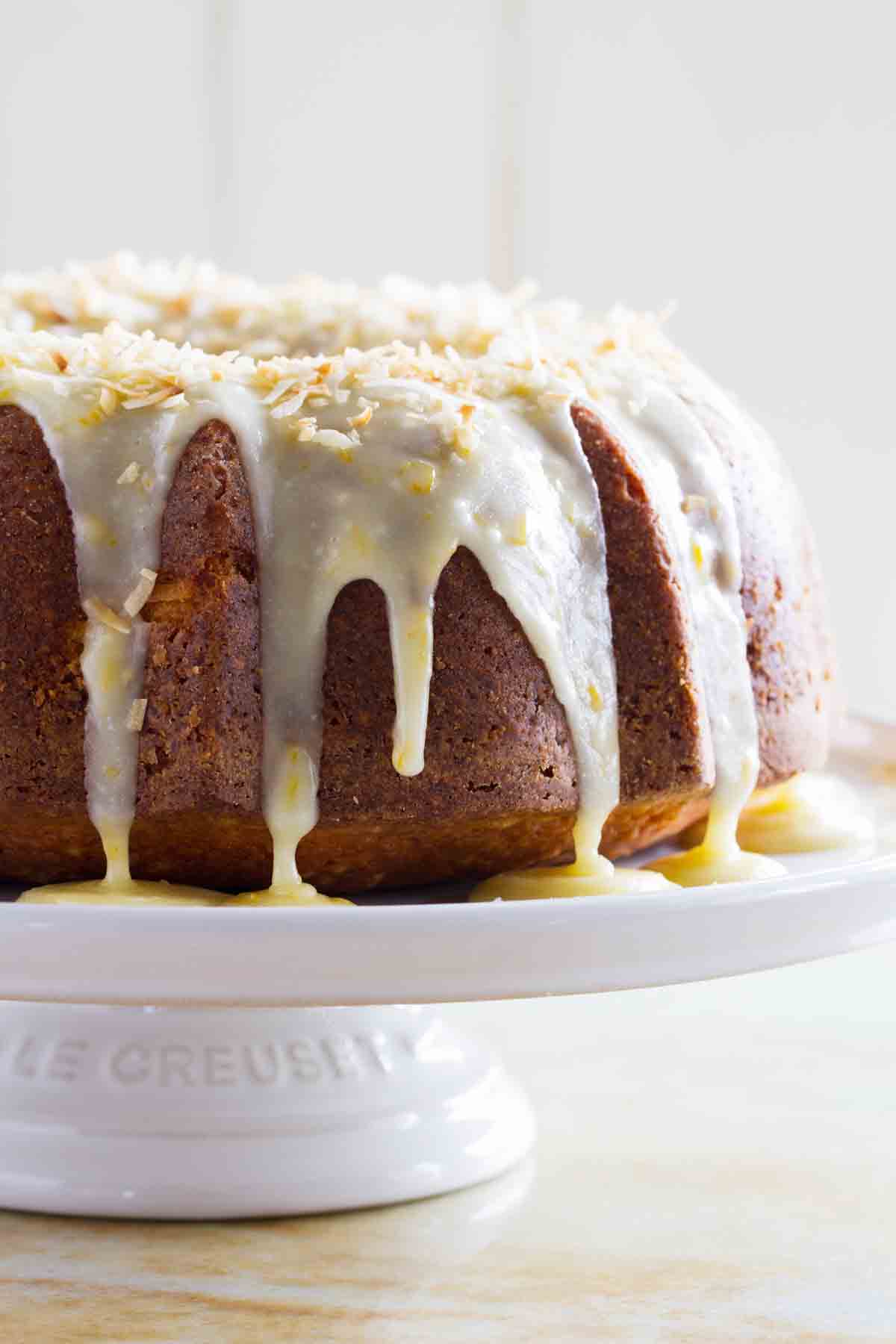 Coconut Orange Pound Cake with icing on a cake plate.