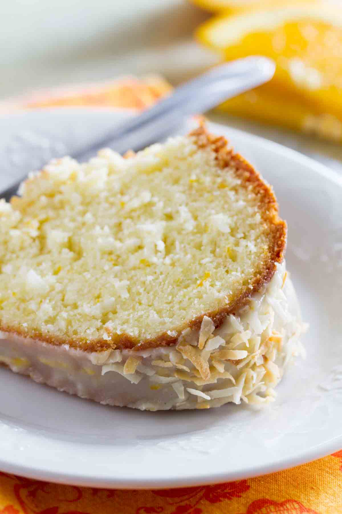 slice of coconut orange pound cake on a plate.