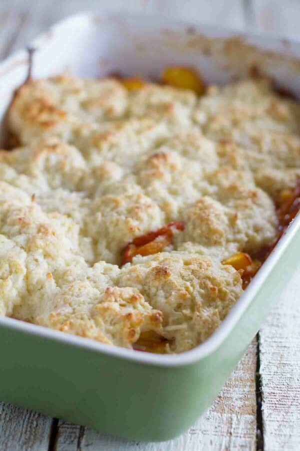 coconut and peach cobbler in a baking dish