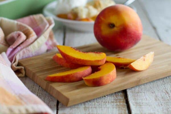 sliced peach on a cutting board