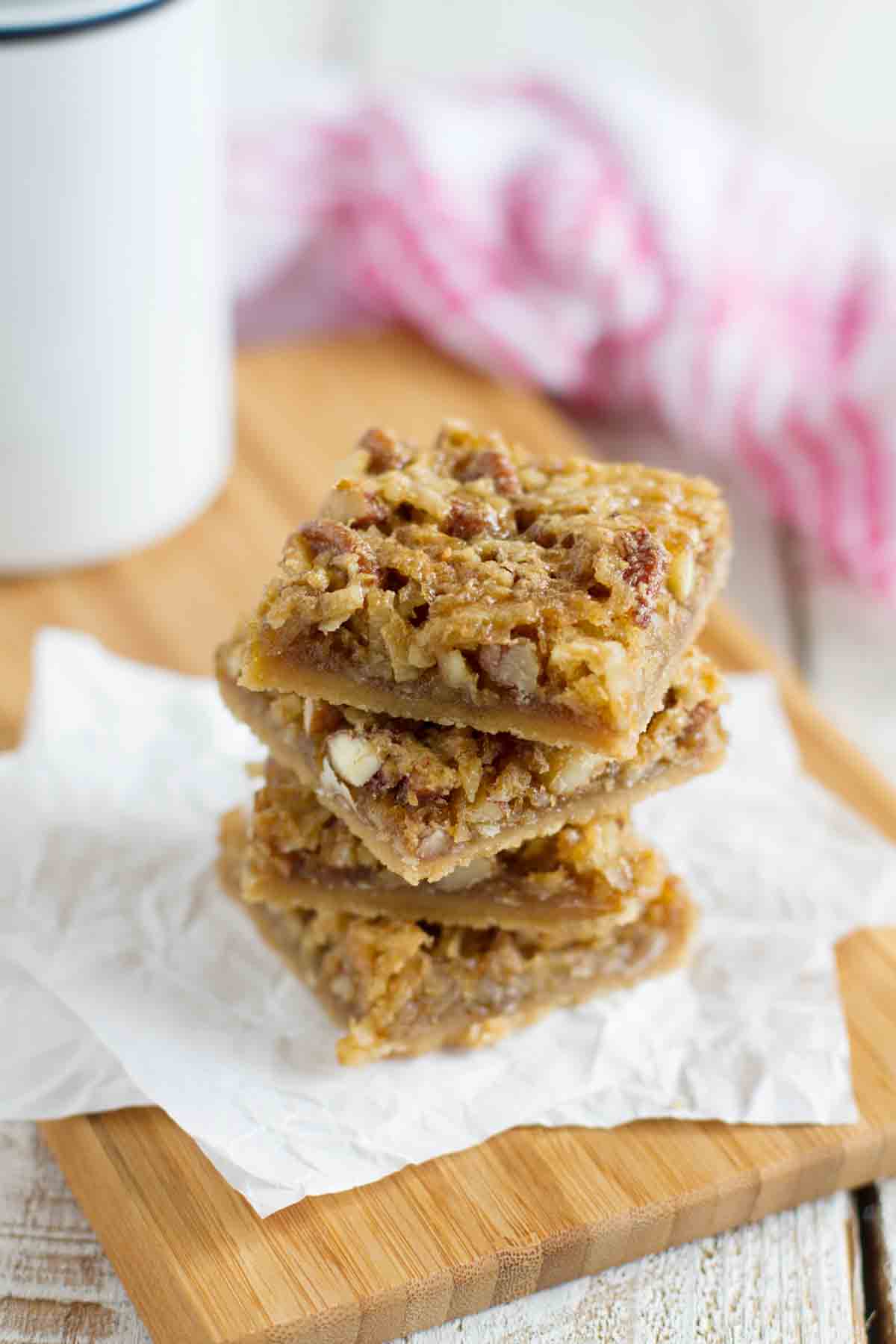 Coconut Pecan Bars stacked on top of each other.