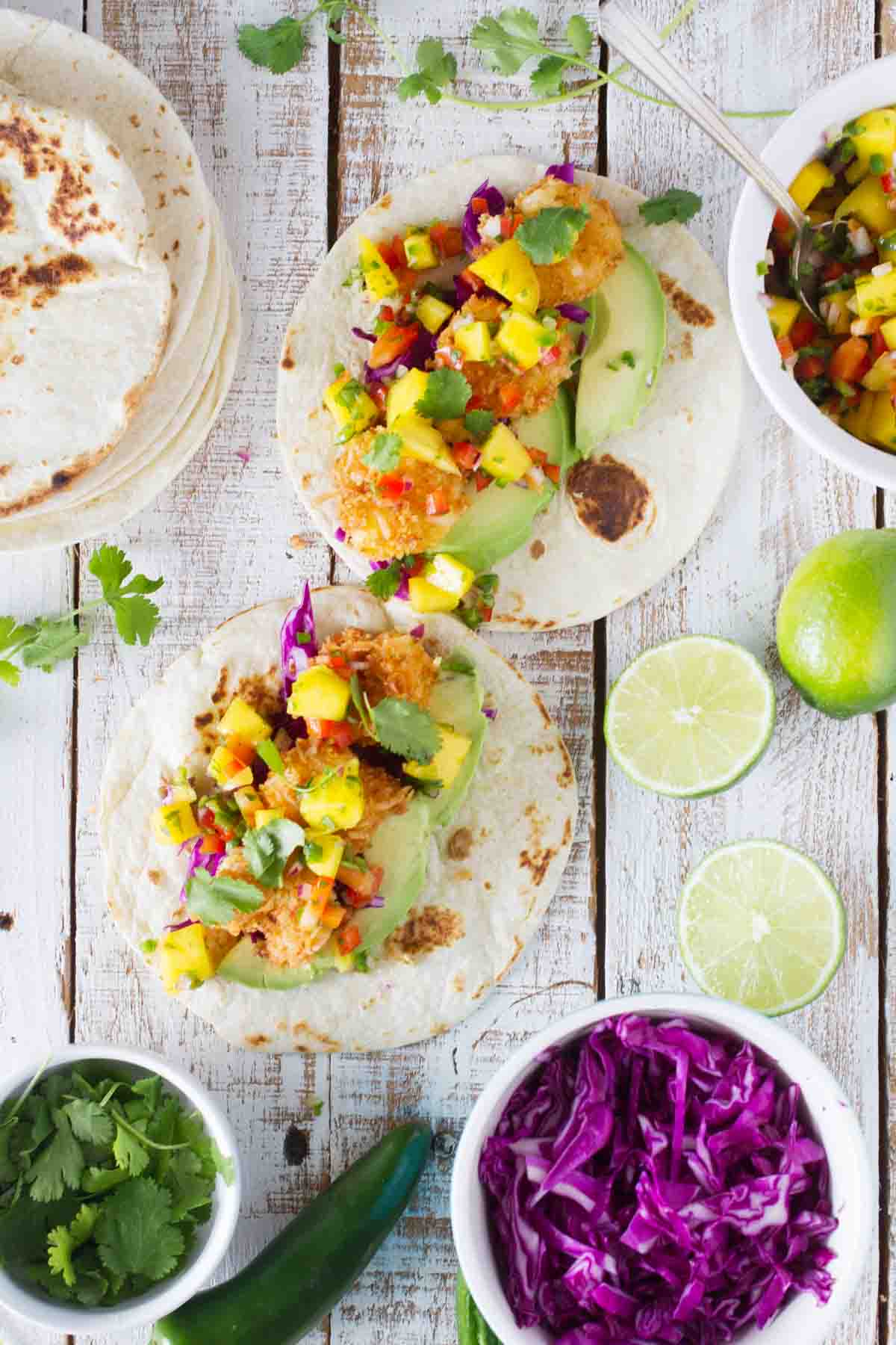 tortillas topped with coconut shrimp and mango salsa