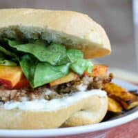 Chicken sandwiches topped with jalapenos and peaches.