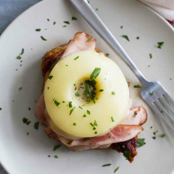 Hawaiian Chicken with Ham and Pineapple on a plate with a fork.