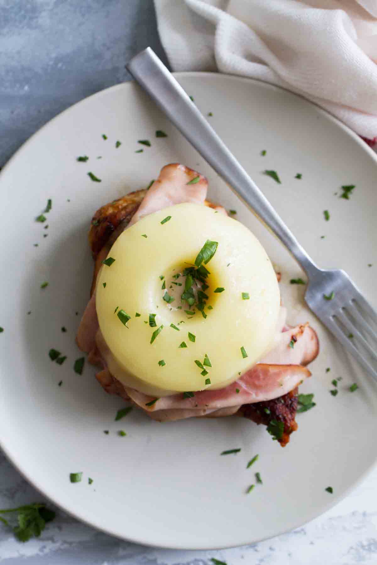 Hawaiian Chicken with Ham and Pineapple on a plate with a fork.