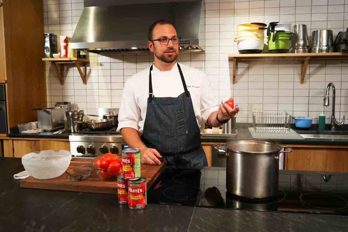 man talking about tomatoes and the canning process.