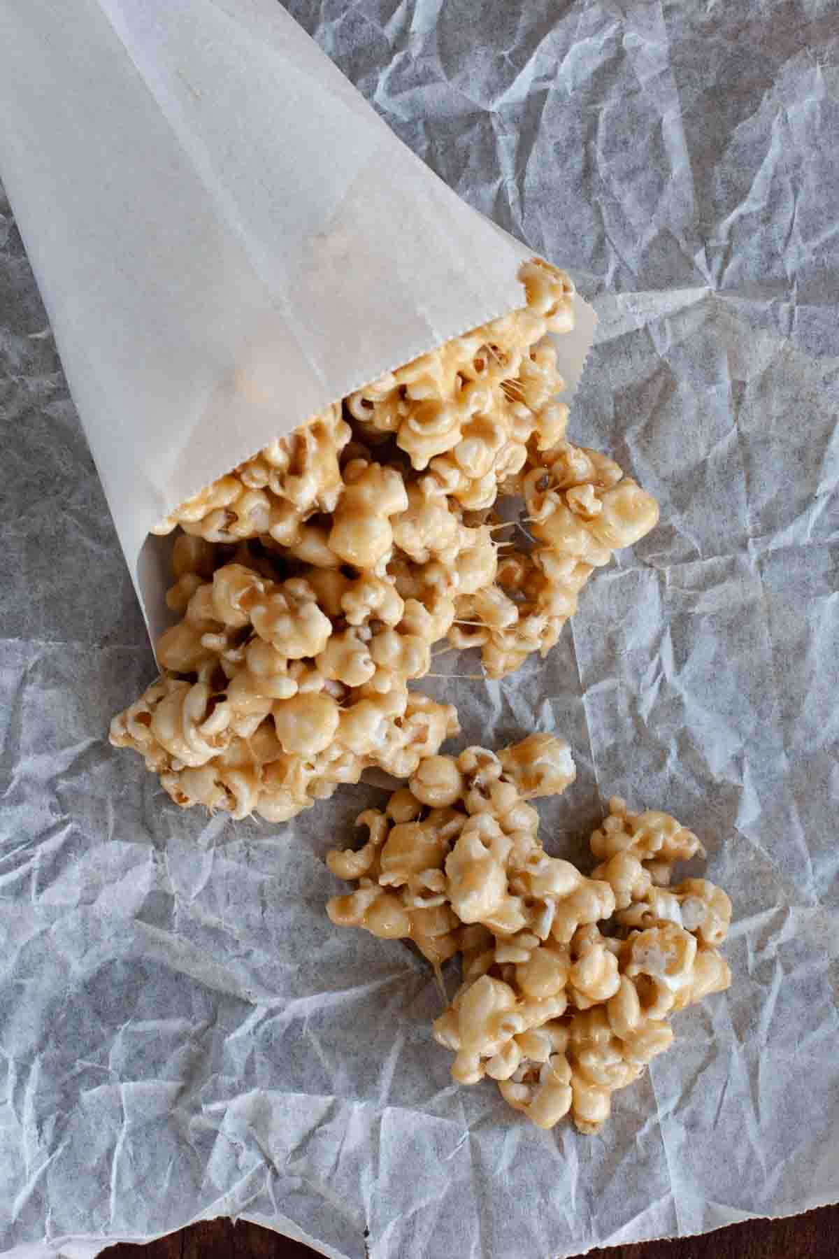 Ooey and gooey, this Marshmallow Caramel Popcorn is coated with a marshmallow and caramel mixture, making it addictive and delicious. Marshmallow Caramel Popcorn in a paper cone