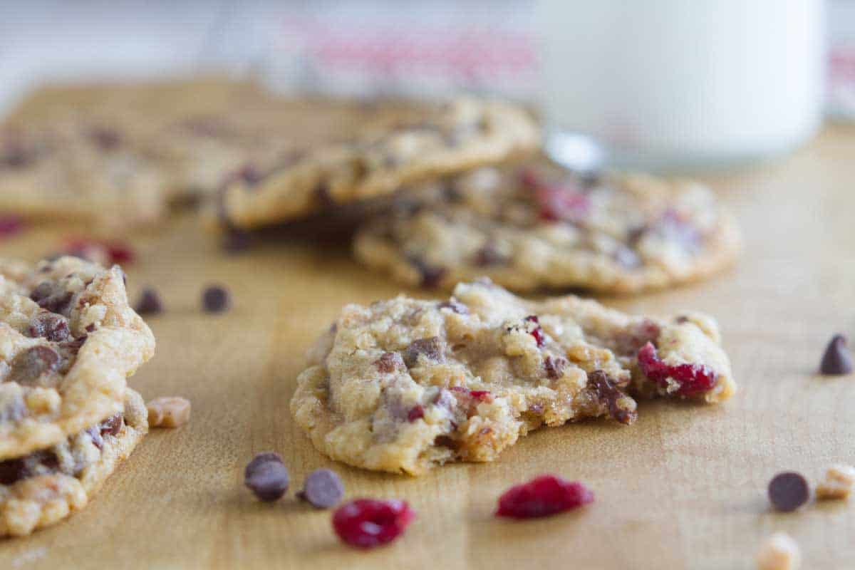 Oatmeal Cranberry Cookies with Chocolate and Toffee, one with a bite taken from it.