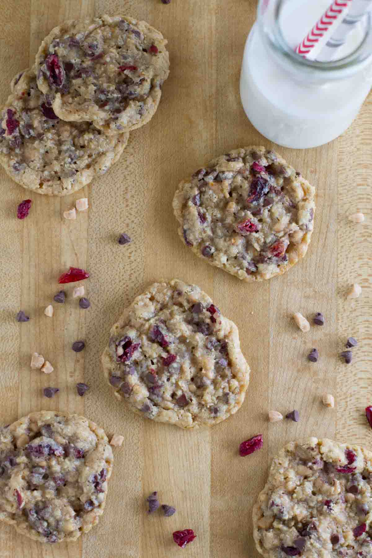 Oatmeal Cranberry Cookies on a cutting board with a glass of milk.