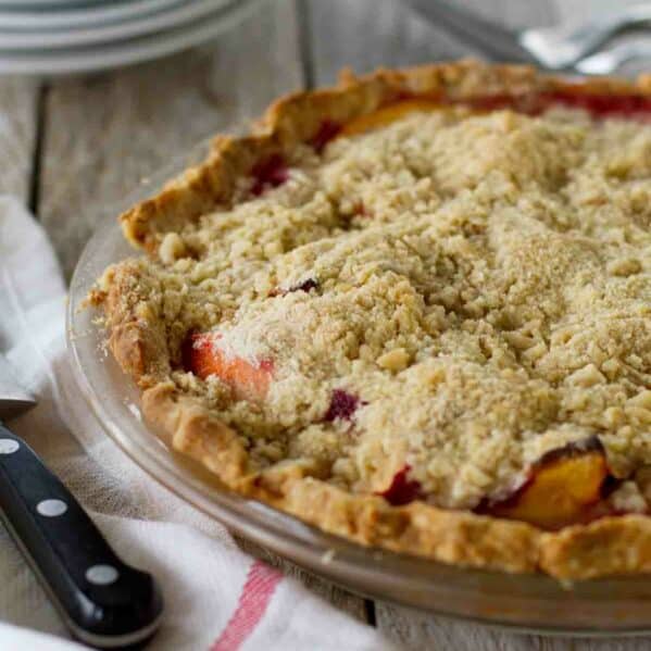 Full Peach Melba Pie topped with crumble topping