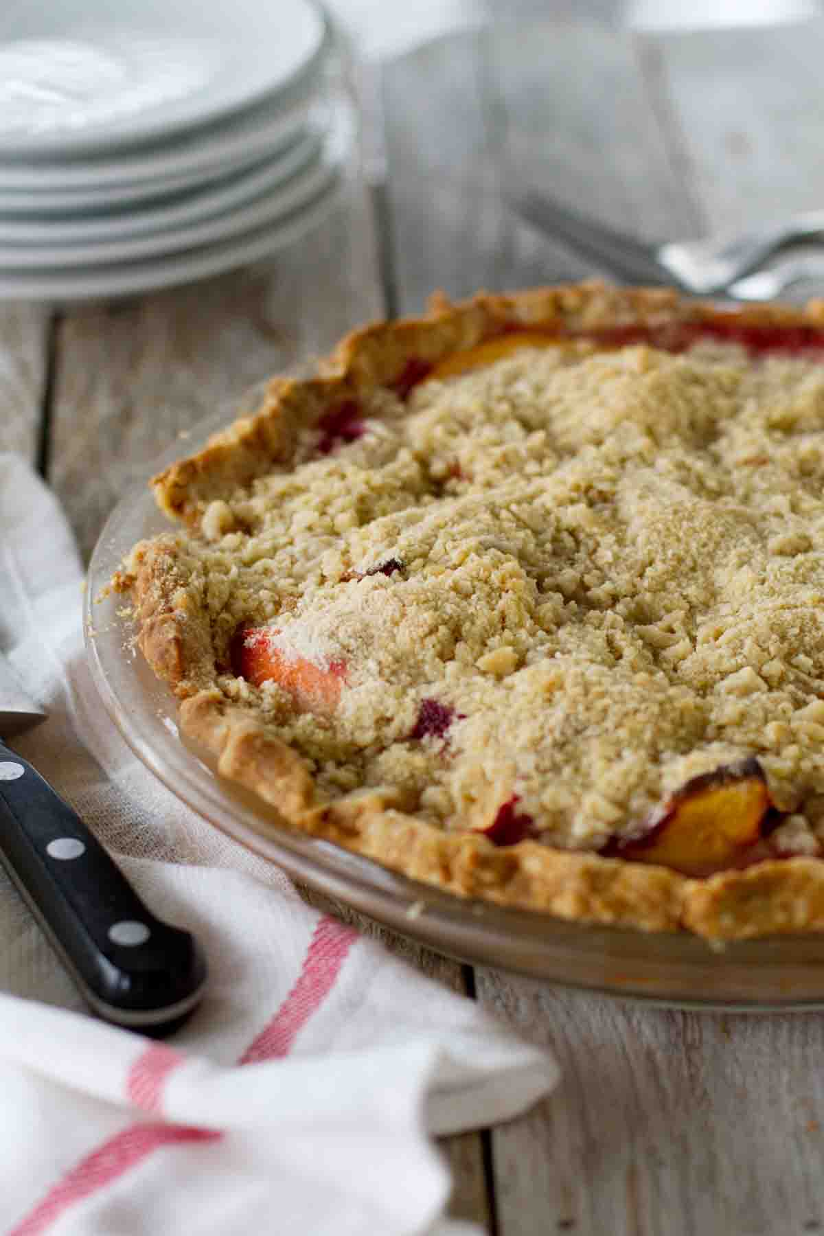 Full Peach Melba Pie topped with crumble topping