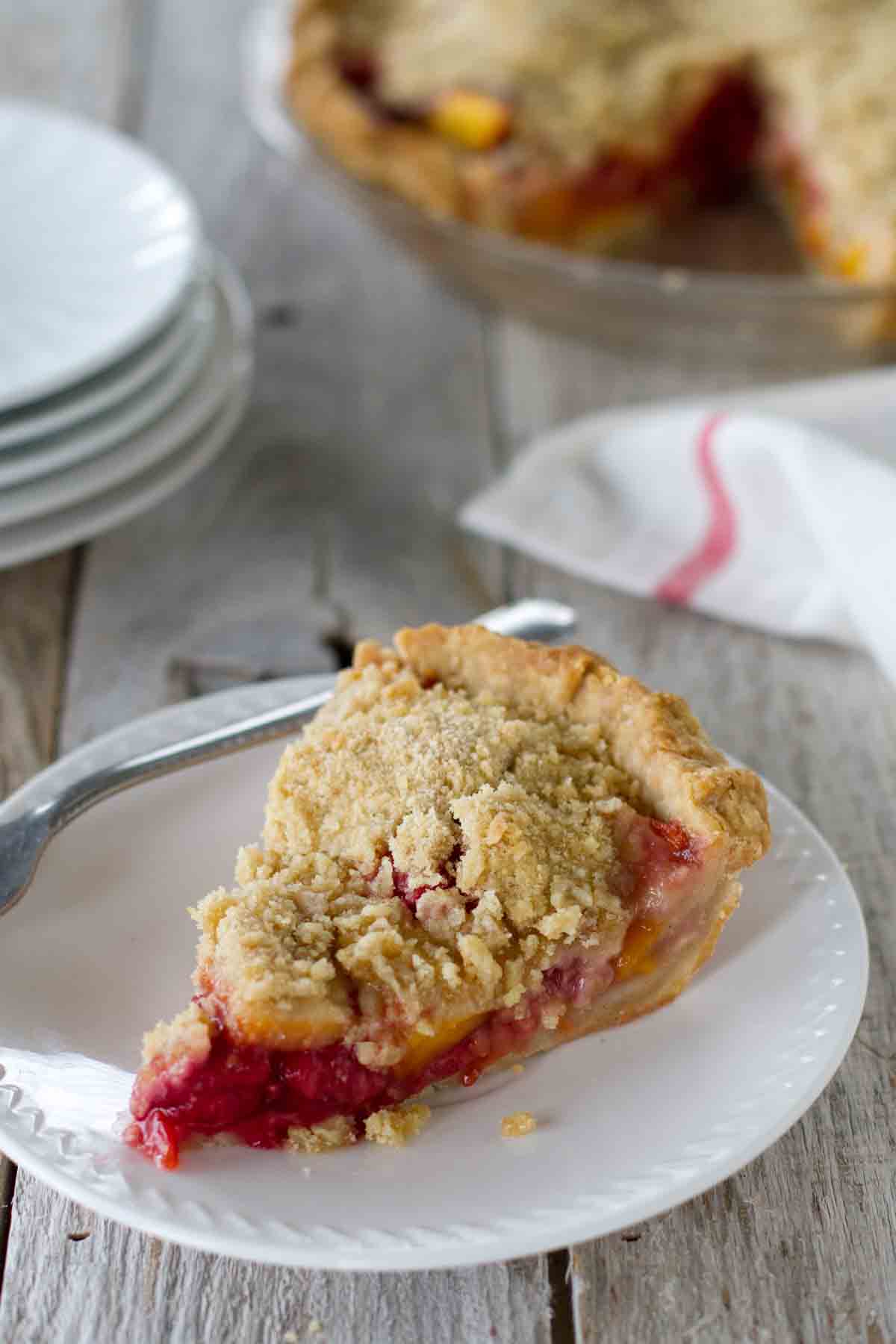 slice of Peach Melba Pie on a white plate