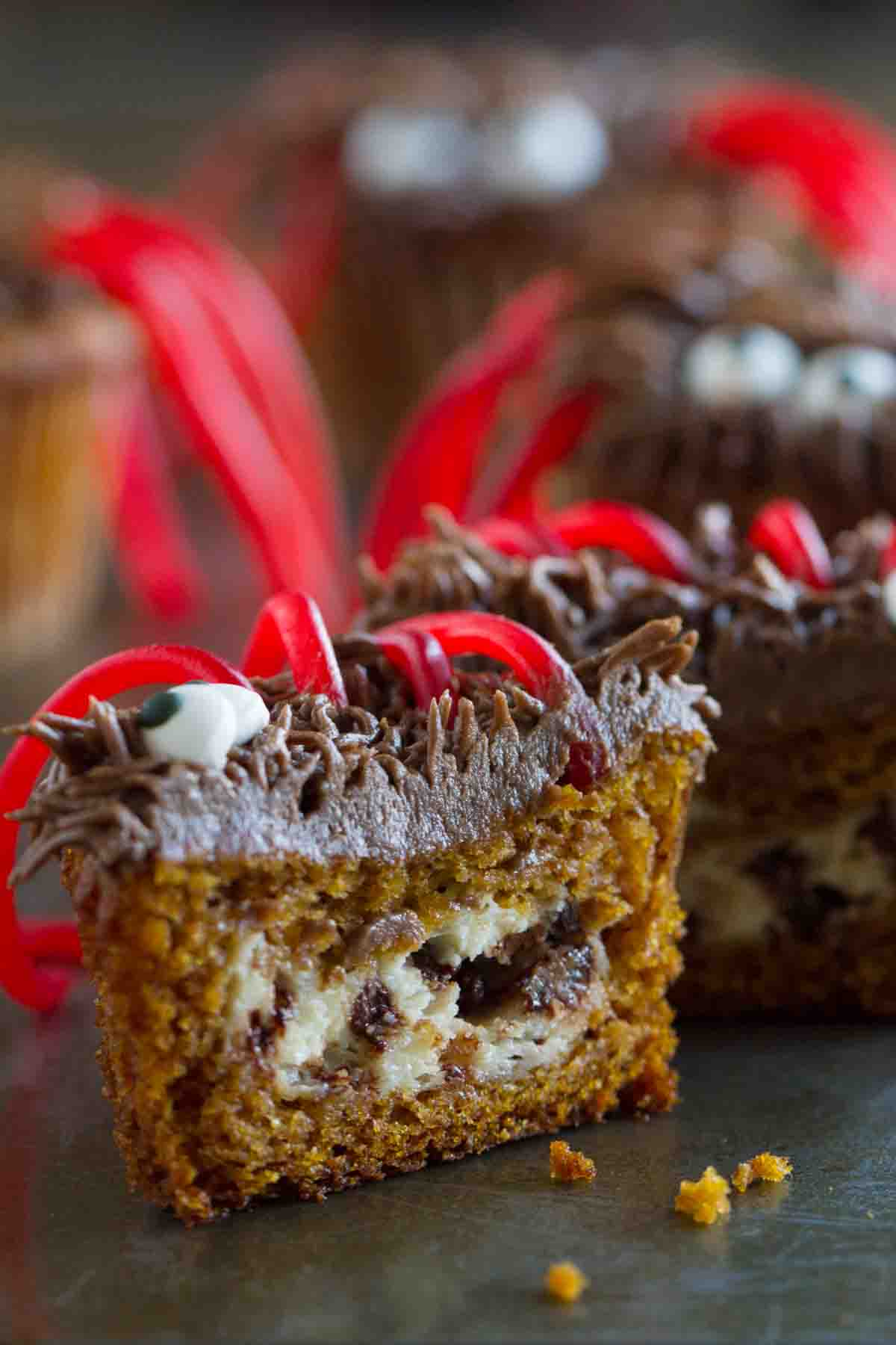 Pumpkin cheesecake cupcake cut open to show cheesecake filling.