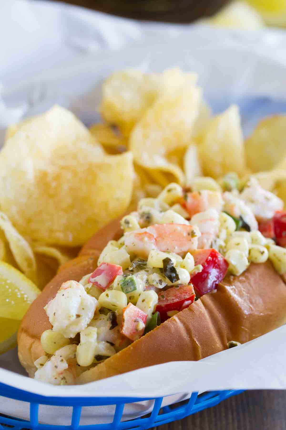 Shrimp roll with corn, peppers, and pesto in a roll.