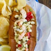 Shrimp rolls made with corn and peppers served with potato chips.