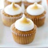 A plate full of Sweet Potato Cupcakes that are topped with toasted marshmallow frosting.