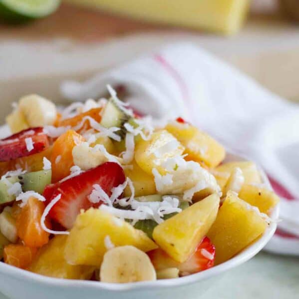 Tropical Fruit Salad topped with coconut in a bowl