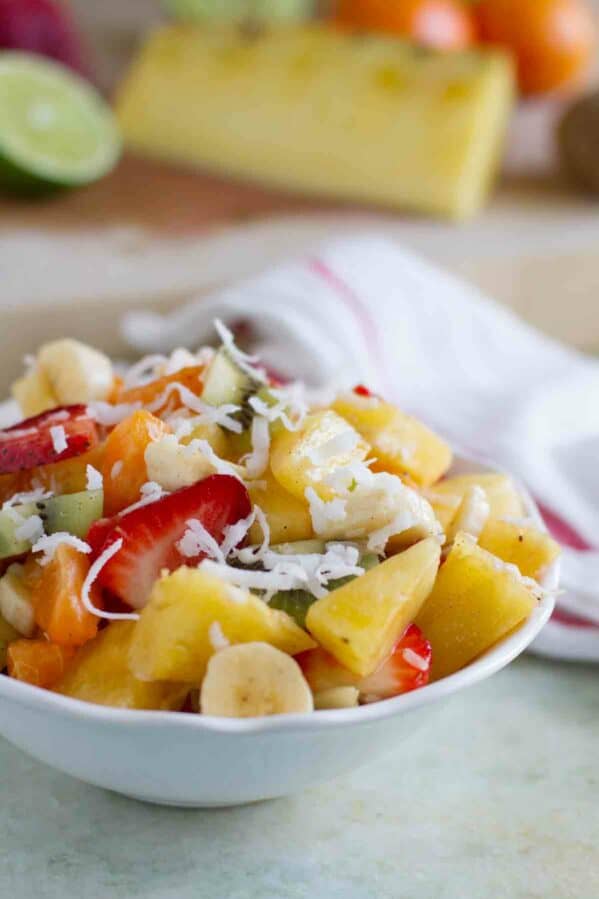 Tropical Fruit Salad topped with coconut in a bowl