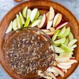 Caramel Apple Dip with red and green sliced apples for dipping.