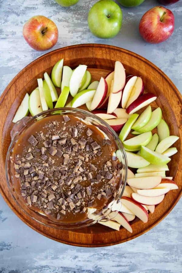 Caramel Apple Dip with red and green sliced apples for dipping.